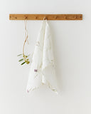 Linen tea towel in Olive orchard print on white