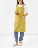 Pinafore cross-back linen apron in Moss yellow
