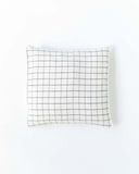 Cushion cover with pom poms in Charcoal grid