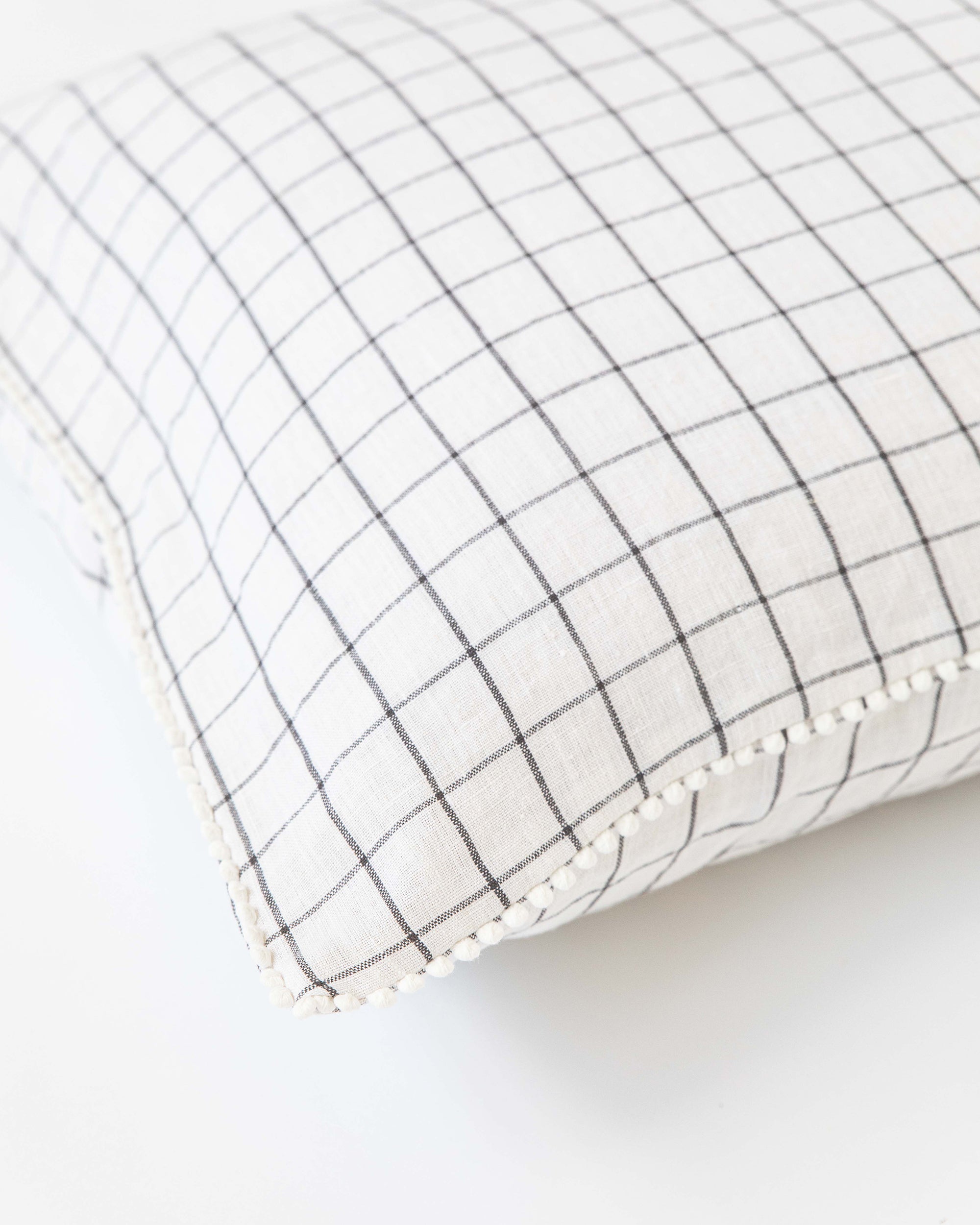 Pom pom trim linen pillowcase in Charcoal grid