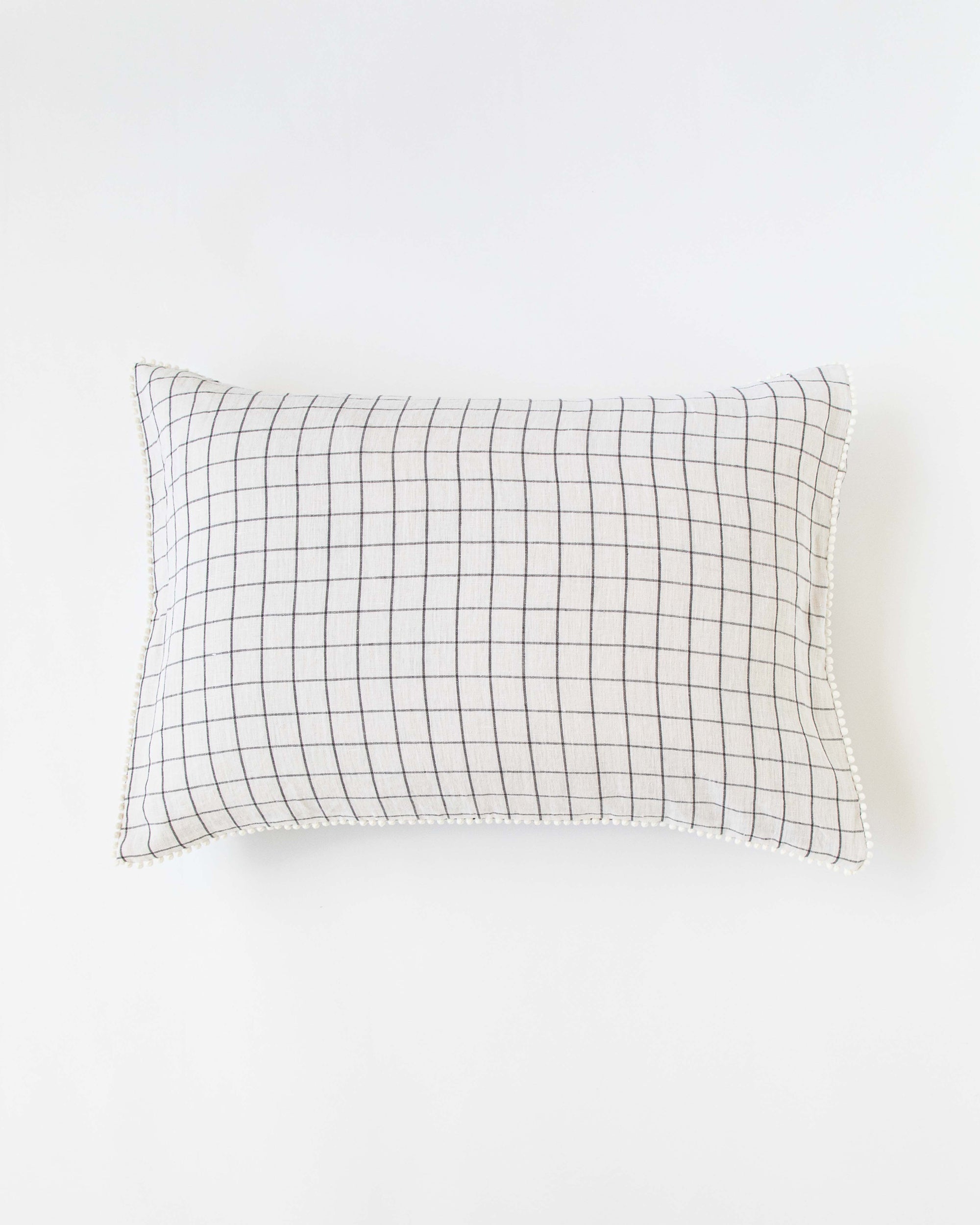 Pom pom trim linen pillowcase in Charcoal grid